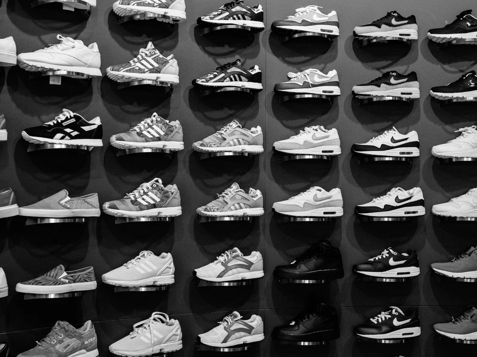 Retail footwear arranged on individual display stands.
