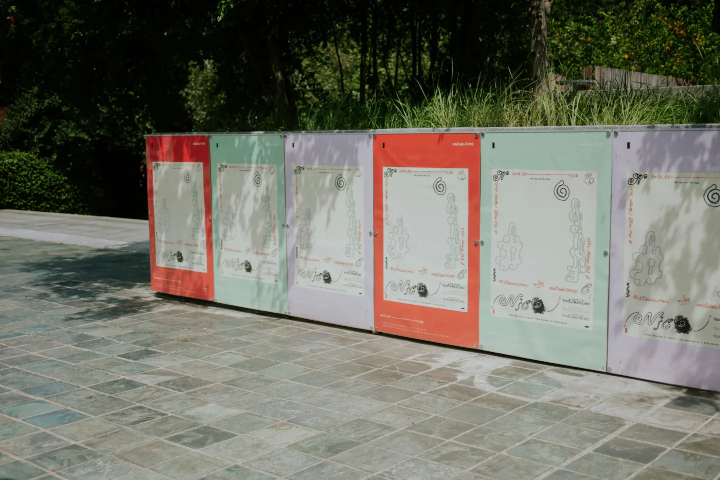 Printed graphic panels installed across an outdoor display structure.