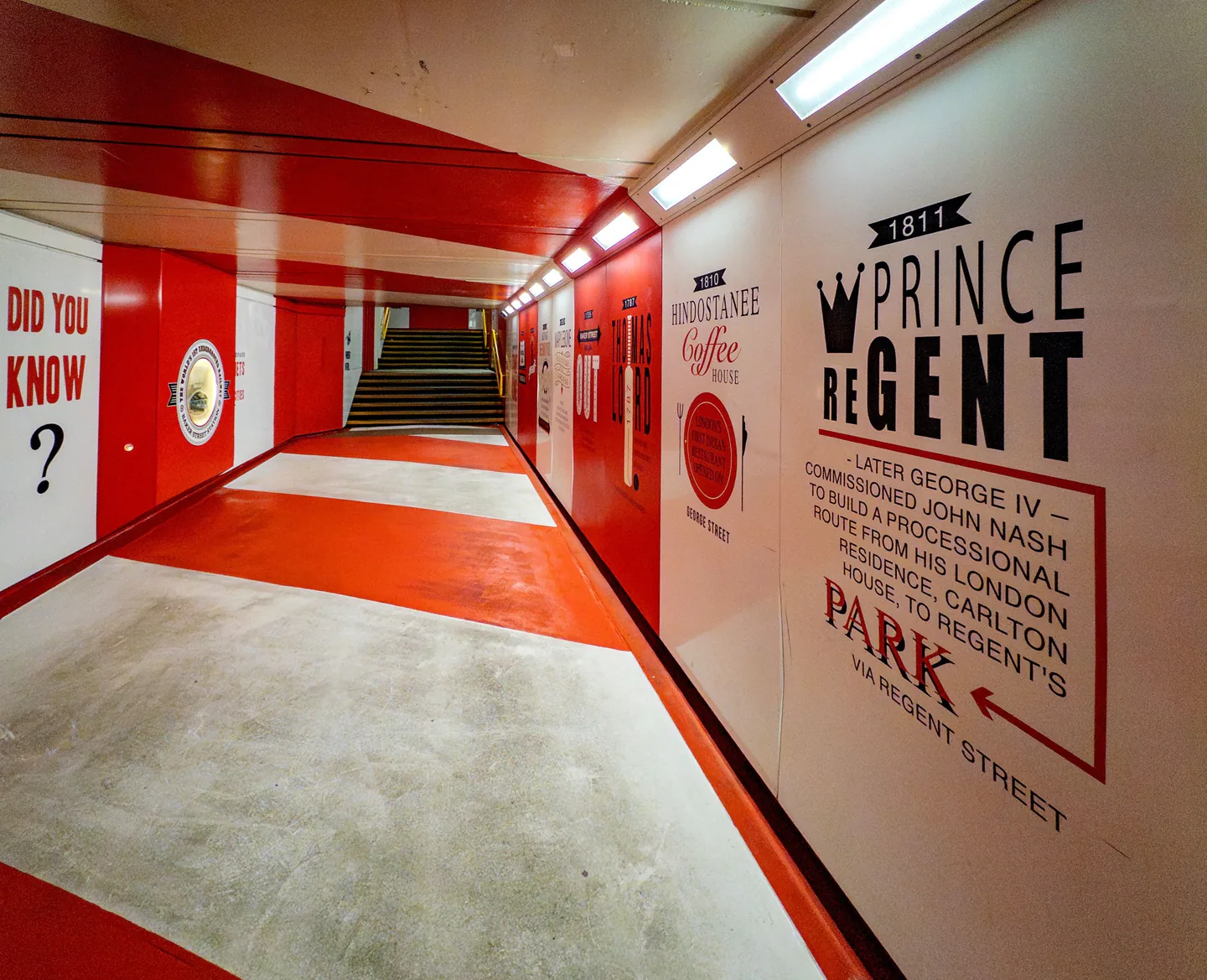 Large branded graphic wall wrapping an exhibition corridor.