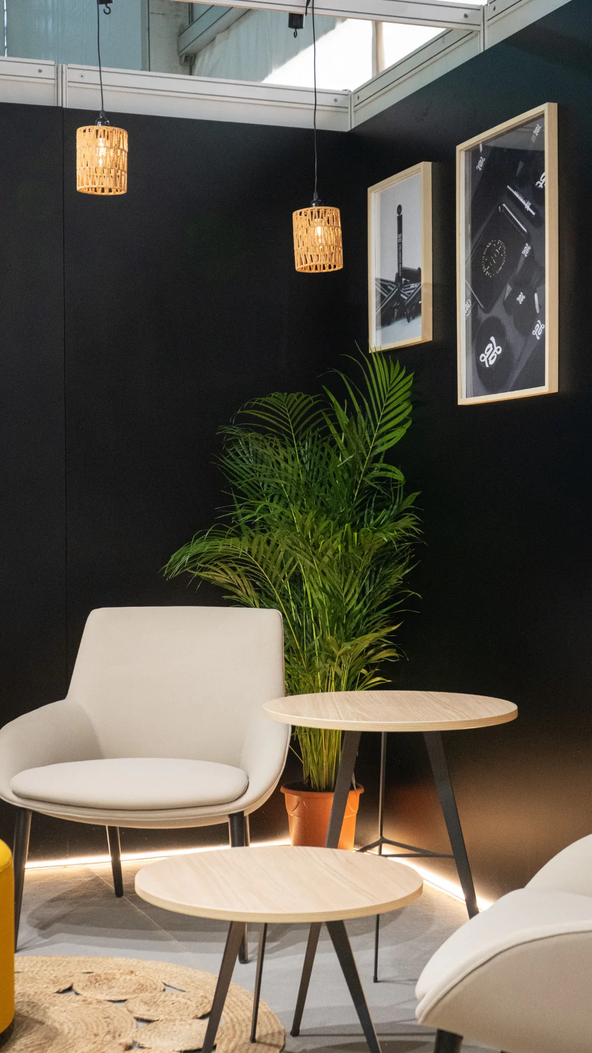 Custom exhibition lounge with counter, planting, framed graphics and integrated lighting.