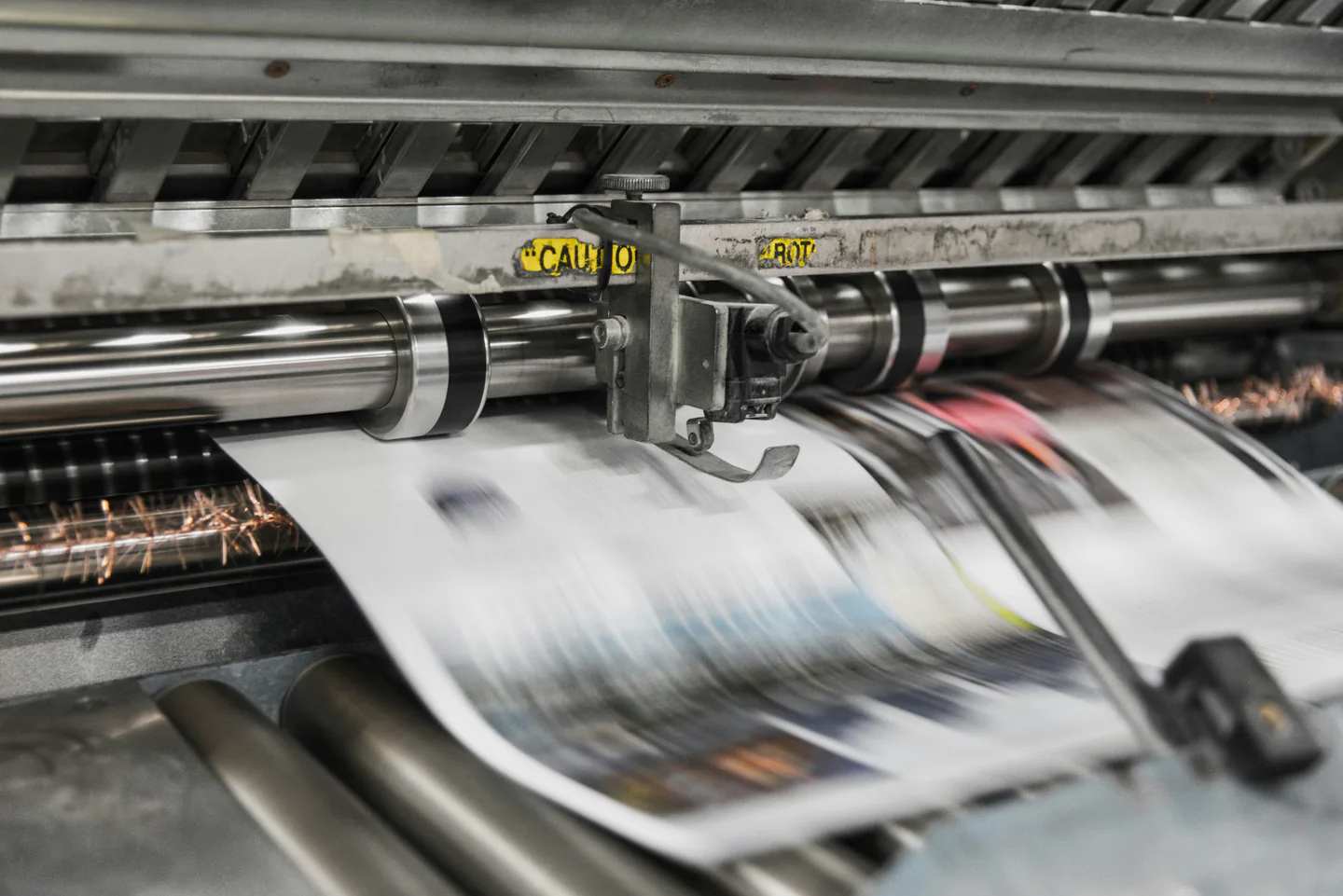 Commercial printing press producing large-format printed material.