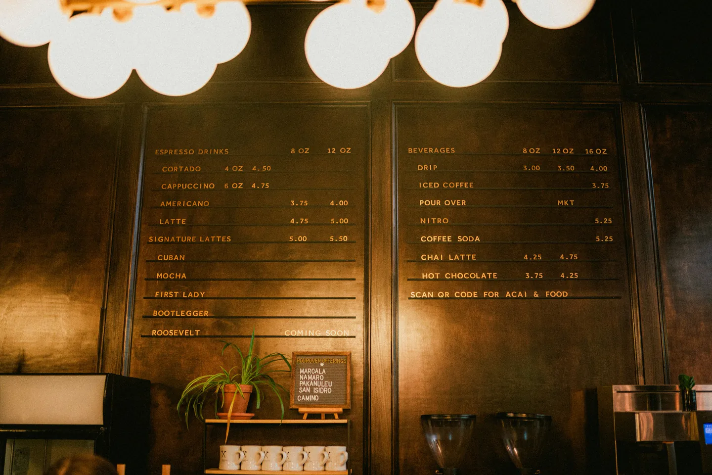 Warm hospitality interior with menu-board style signage and clear branded information.