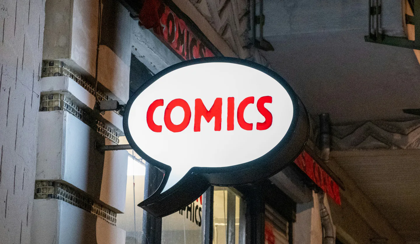 Illuminated speech-bubble shopfront sign.